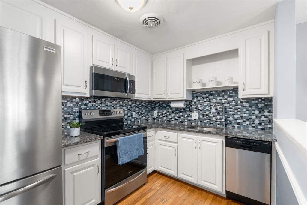 32 Whitman Road, Unit 14 Waltham, MA 02453 - Photo 6 of 20 a kitchen with appliances a sink and cabinets