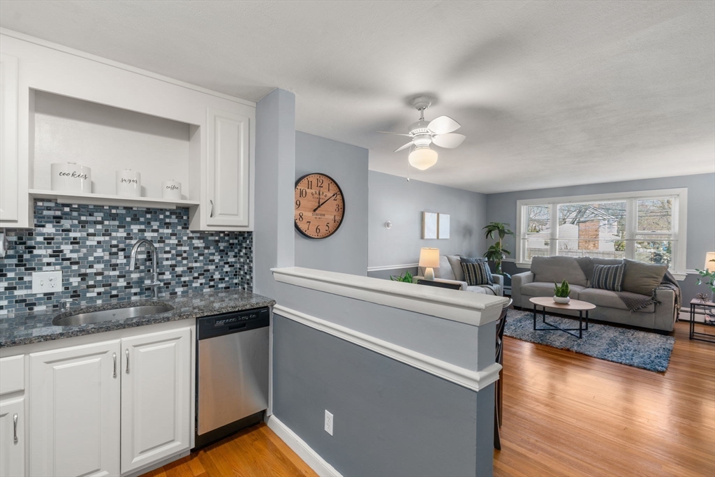 32 Whitman Road, Unit 14 Waltham, MA 02453 - Photo 8 of 20 a living room with granite countertop furniture a fireplace and a window