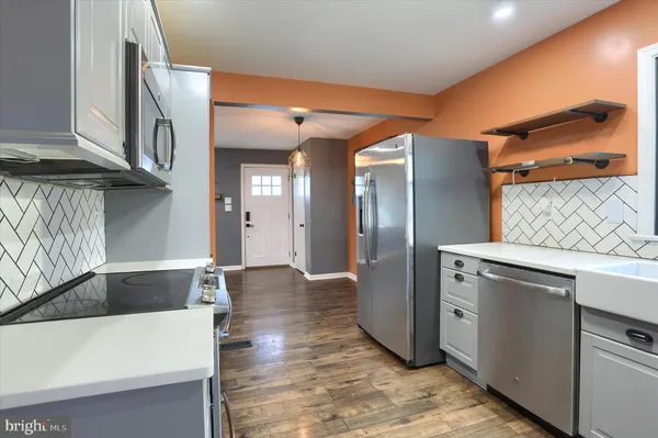 a kitchen with stainless steel appliances granite countertop a refrigerator and a sink