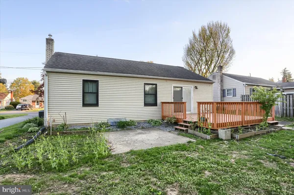 a backyard of a house with a garden and deck
