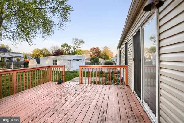 a view of balcony with wooden floor and fence