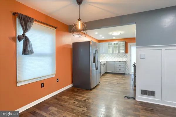 a view of a kitchen with a refrigerator and a window