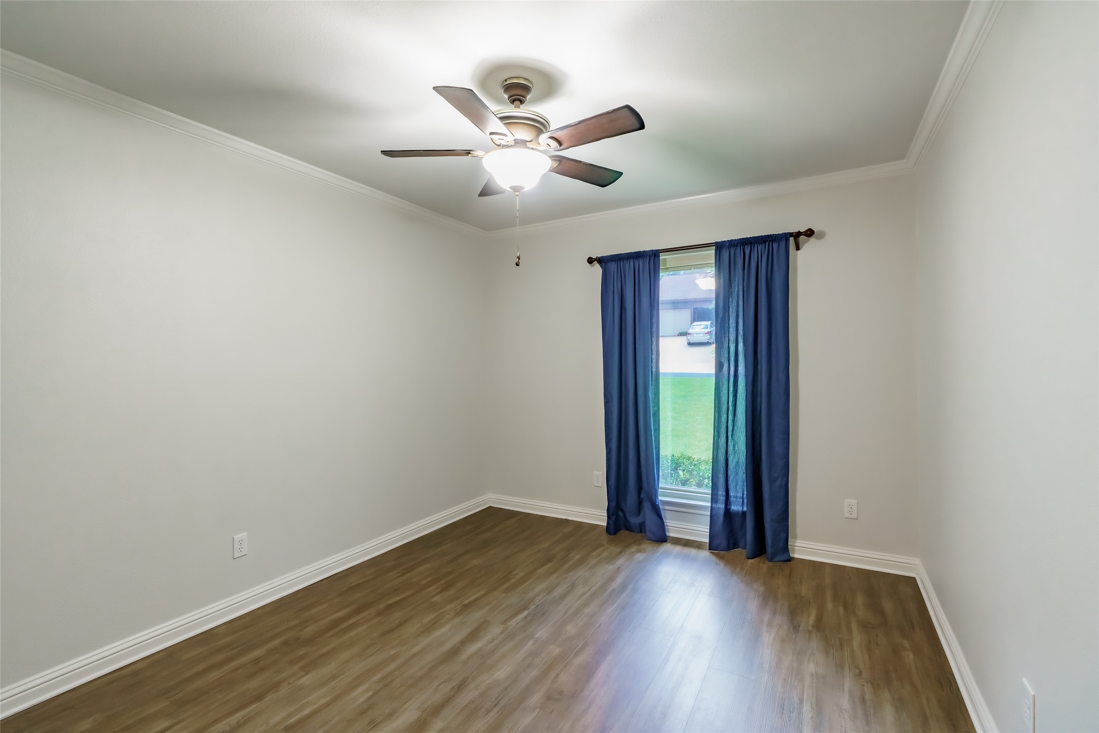 8810 Mountain Path Circle Austin, TX 78759 - Photo 12 of 37 Empty room featuring dark wood-type flooring, ornamental molding, and ceiling fan