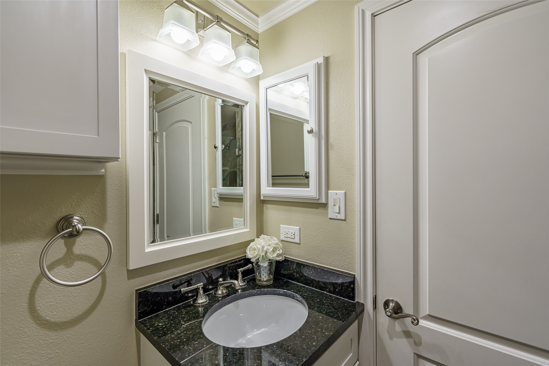 8810 Mountain Path Circle Austin, TX 78759 - Photo 27 of 37 Half bathroom featuring a textured wall, vanity, and ornamental molding