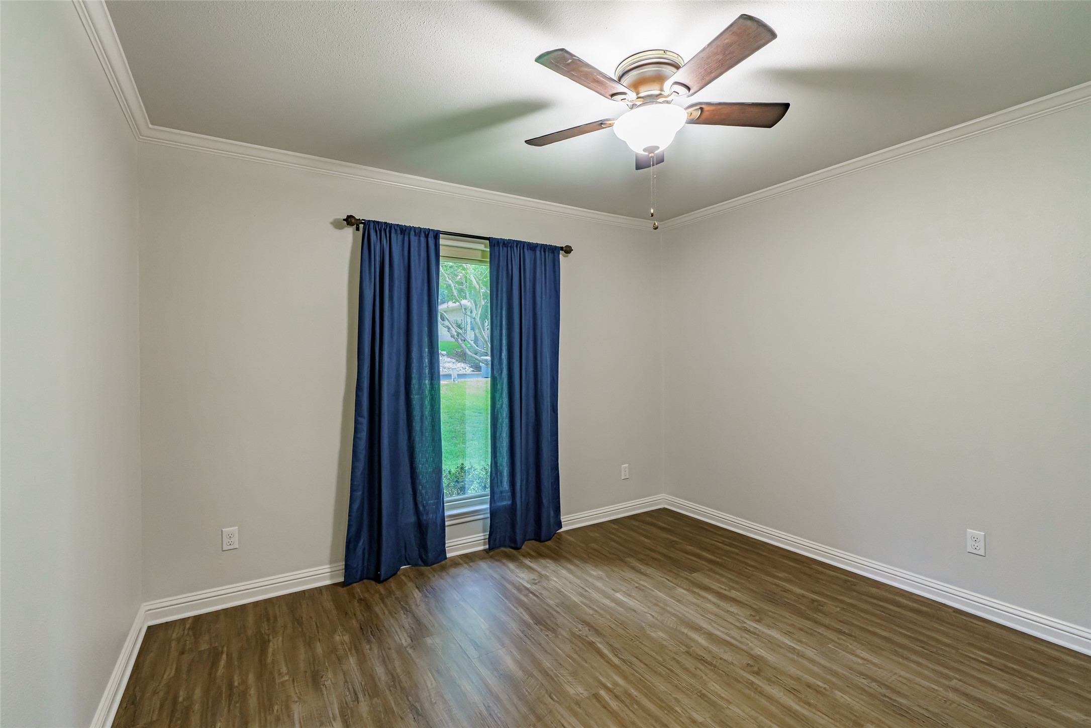 8810 Mountain Path Circle Austin, TX 78759 - Photo 10 of 37 Spare room featuring dark wood-style floors, ornamental molding, and ceiling fan