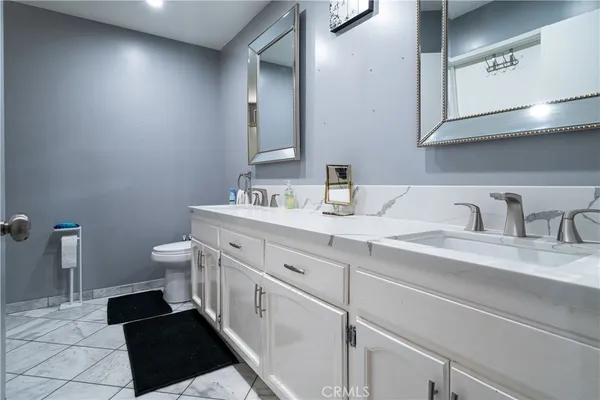 a bathroom with a double vanity sink and a mirror