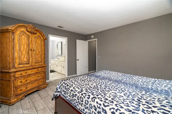 a bedroom with a bed and dresser