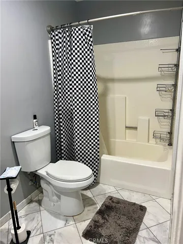 a bed room with a bed and a chair