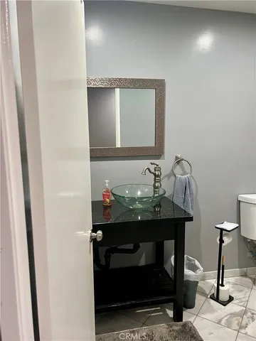 a backyard of a house with large trees and plants