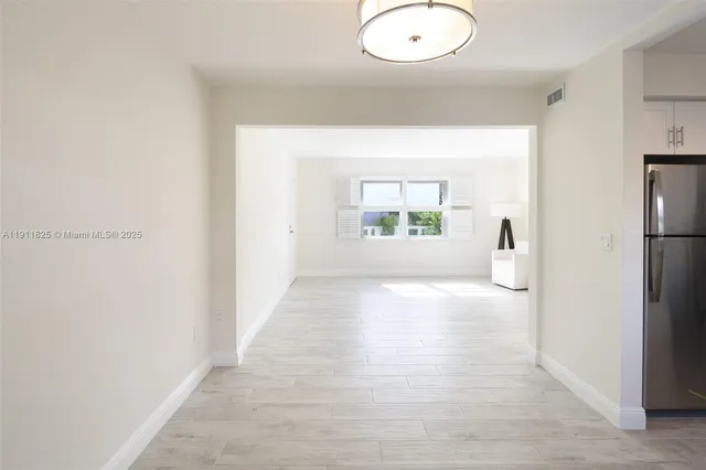 an empty room with windows and entrance