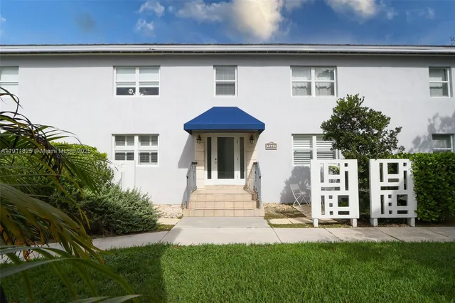 a front view of a house with a garden and plants
