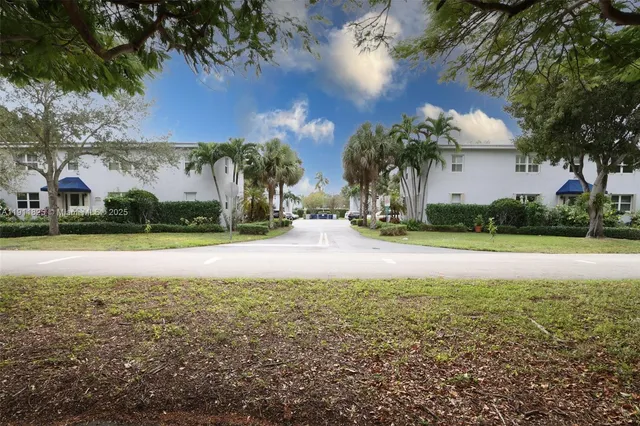 a view of house with yard and swimming pool