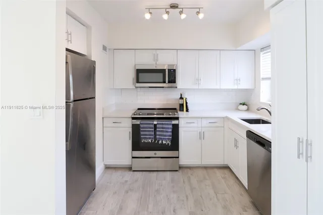 a kitchen with a refrigerator stove and microwave