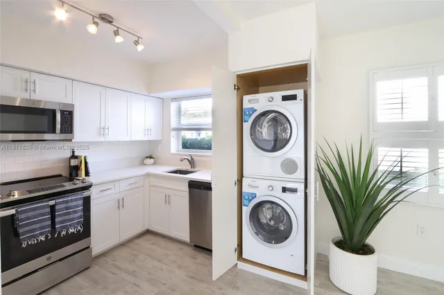 a view of a kitchen with washer and dryer