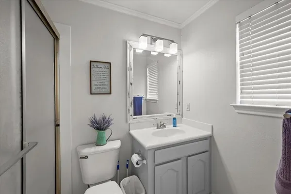 a view with a double vanity sink mirror and cabinets