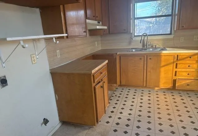 a bathroom with a sink a vanity and a shower