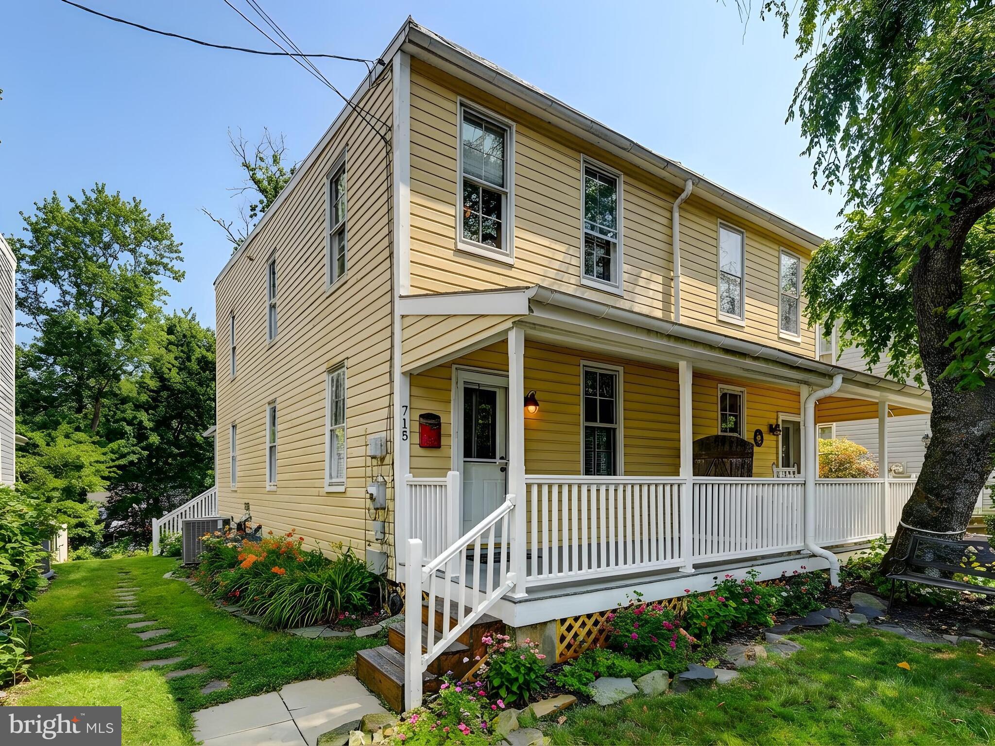 715 Pleasant Hill Road Ellicott City, MD 21043 - Photo 2 of 27 a front view of a house with a garden