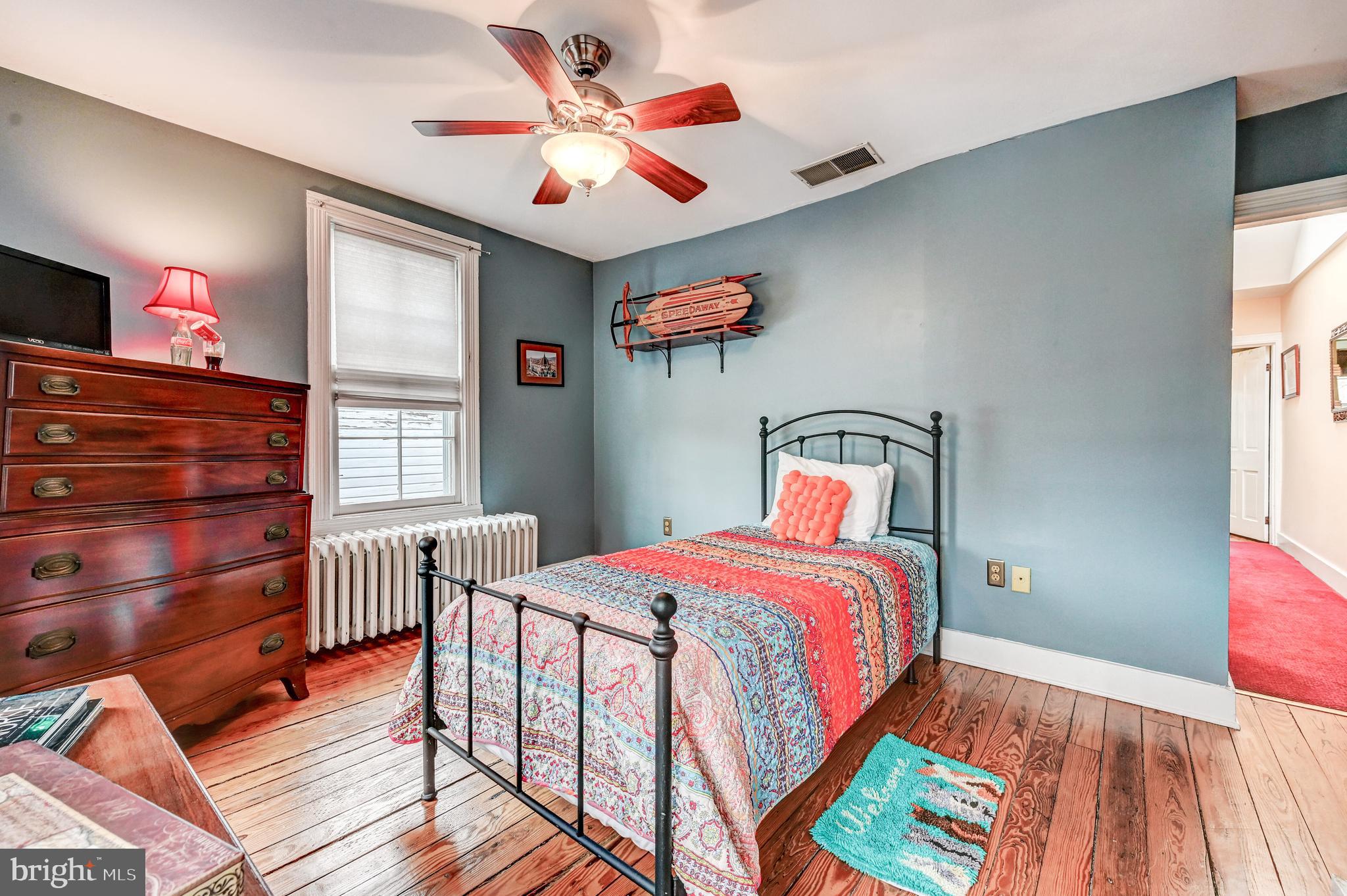 715 Pleasant Hill Road Ellicott City, MD 21043 - Photo 23 of 27 a bedroom with a bed and a chandelier