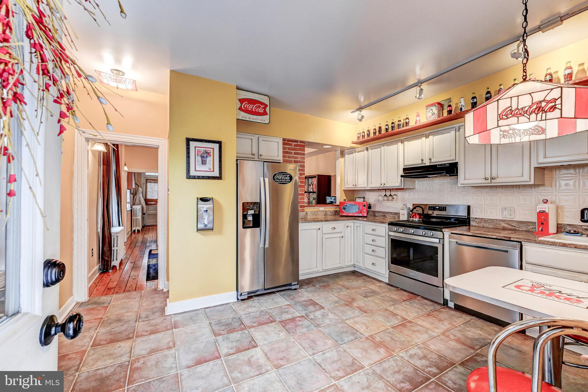 715 Pleasant Hill Road Ellicott City, MD 21043 - Photo 6 of 27 a kitchen with stainless steel appliances granite countertop a refrigerator and a stove top oven