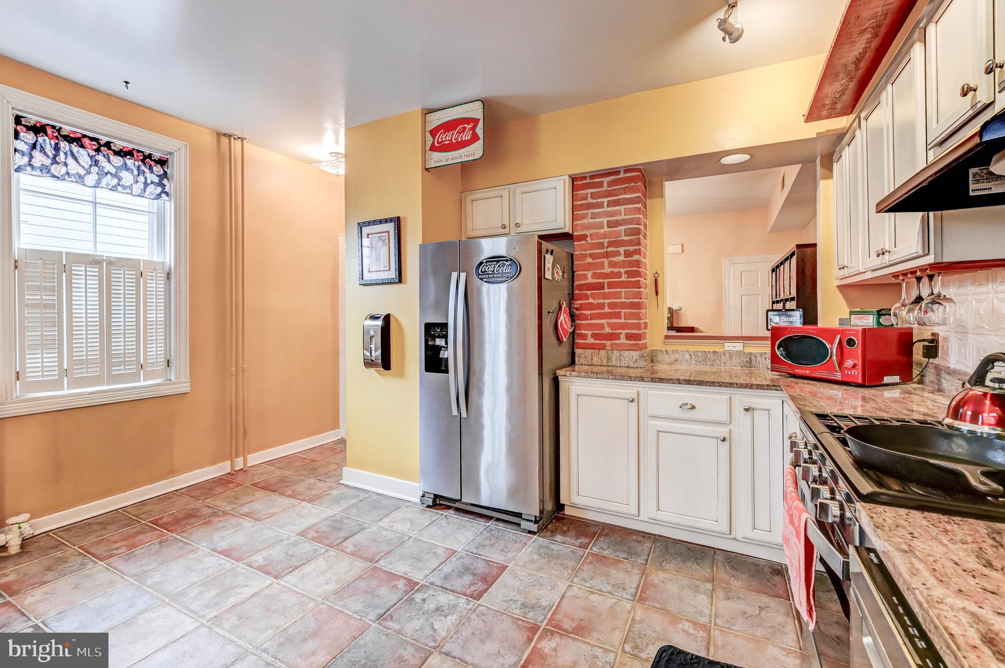 715 Pleasant Hill Road Ellicott City, MD 21043 - Photo 7 of 27 a kitchen with stainless steel appliances granite countertop a refrigerator and a stove
