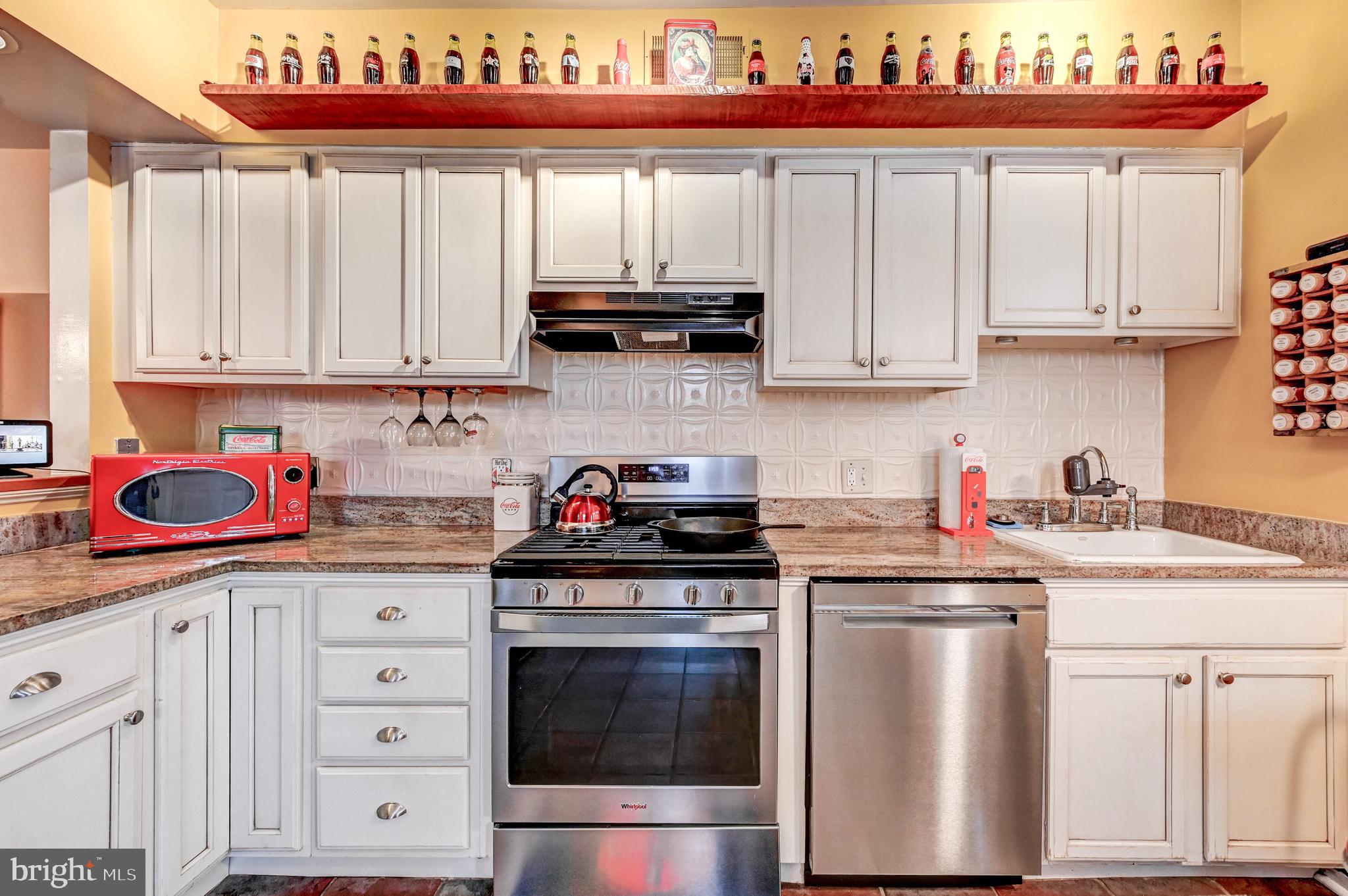 715 Pleasant Hill Road Ellicott City, MD 21043 - Photo 8 of 27 a kitchen with stainless steel appliances granite countertop a stove a sink dishwasher and cabinets with wooden floor