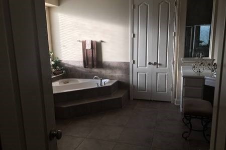 7606 Crystal Isle Lane Humble, TX 77396 - Photo 8 of 10 a spacious bathroom with a double vanity sink and a mirror