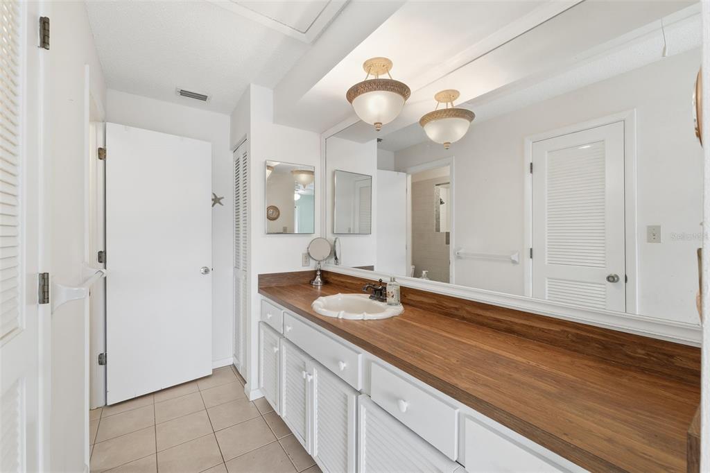 1804 Rising Sun Drive, Unit 1804 Holiday, FL 34690 - Photo 17 of 31 a bathroom with a granite countertop sink and a mirror