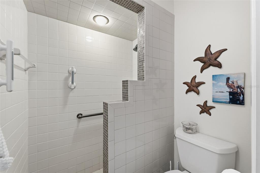 1804 Rising Sun Drive, Unit 1804 Holiday, FL 34690 - Photo 18 of 31 a bathroom with a toilet and a shower