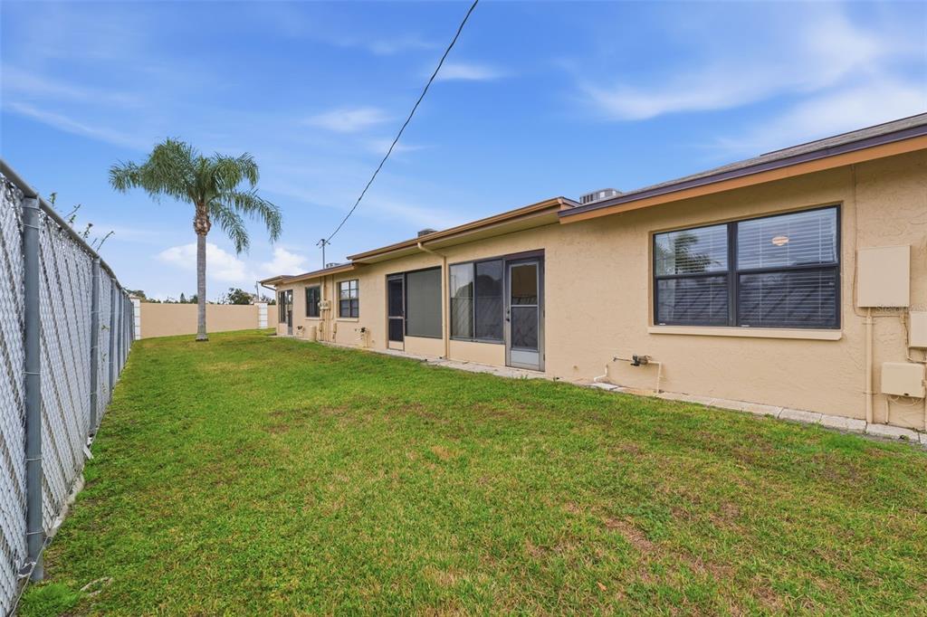 1804 Rising Sun Drive, Unit 1804 Holiday, FL 34690 - Photo 27 of 31 a view of a house with backyard and porch