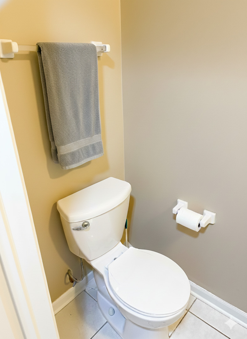1137 Brent Road Northbrook, IL 60062 - Photo 14 of 25 a white toilet sitting next to a bathroom sink