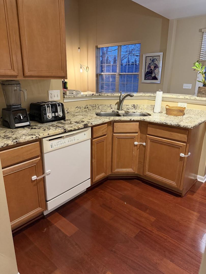 1137 Brent Road Northbrook, IL 60062 - Photo 8 of 25 a kitchen with stainless steel appliances granite countertop a sink stove and cabinets