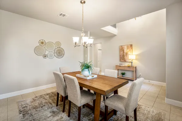 a view of a dining room with furniture and chandelier