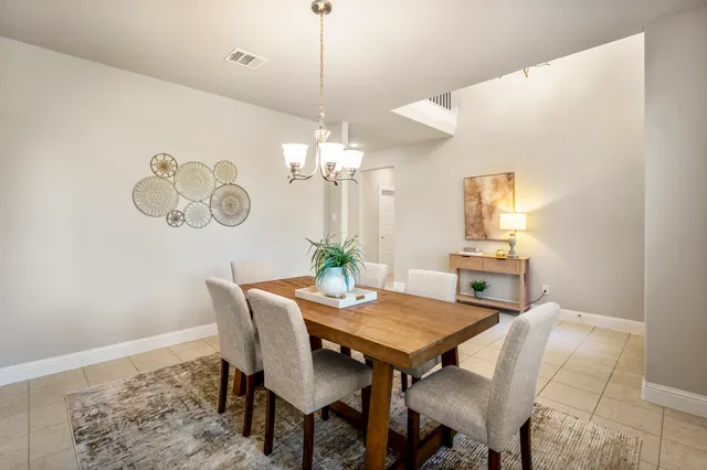 a view of a dining room with furniture and chandelier