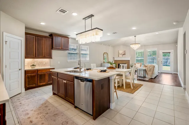 a kitchen with stainless steel appliances granite countertop a stove and a refrigerator