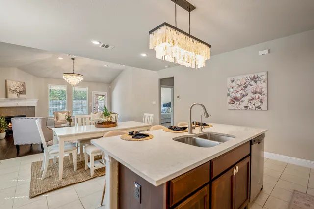 a view of a dining room with furniture a chandelier and wooden floor