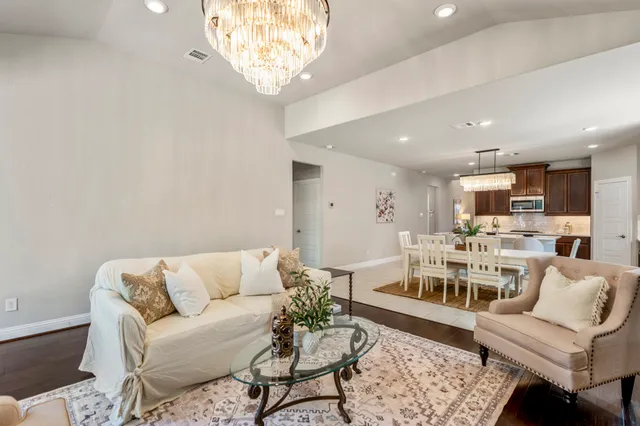 a living room with furniture and a chandelier