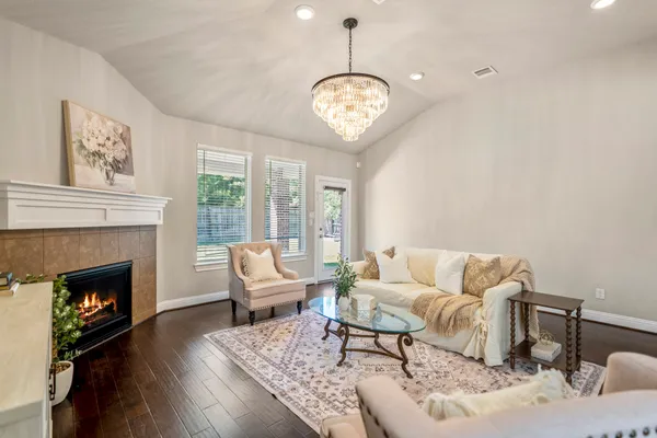 a living room with furniture chandelier and a fireplace