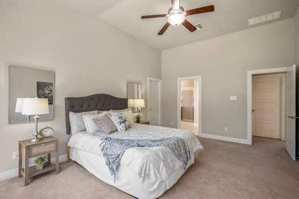 a bedroom with a bed and a lamp