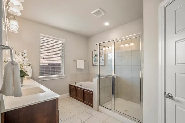 a bathroom with a shower sink and mirror