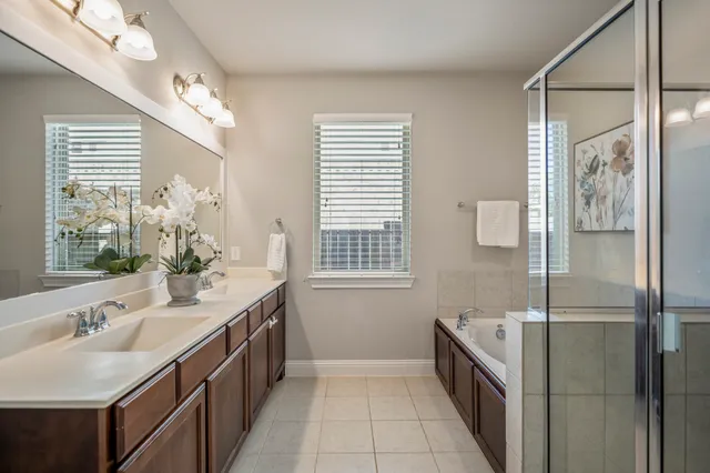 a bathroom with a tub sink and mirror