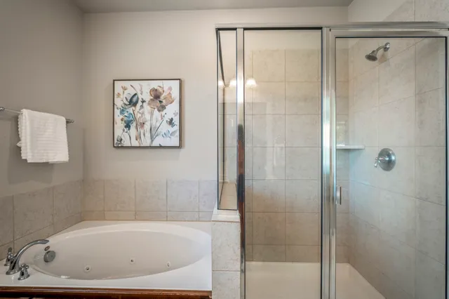 a white bath tub sitting next to a shower