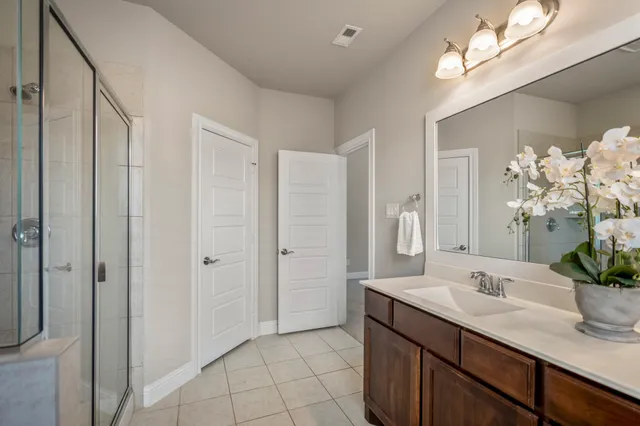 a bathroom with a double vanity sink and a mirror