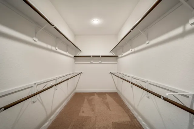 a view of a hallway with wooden floor and stairs