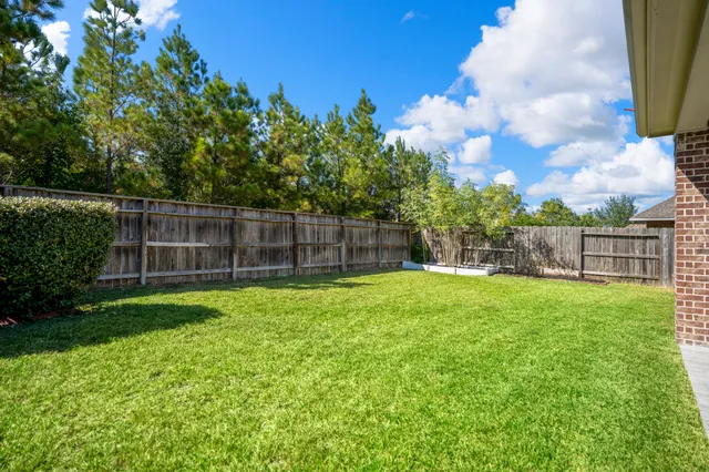 a view of a house with a yard and porch