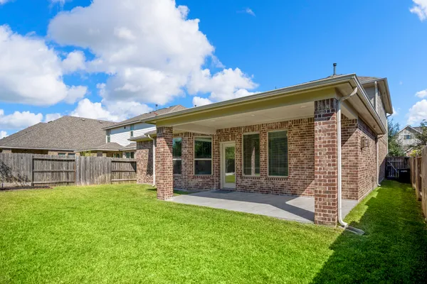 an aerial view of a house with a yard basket ball court and outdoor seating