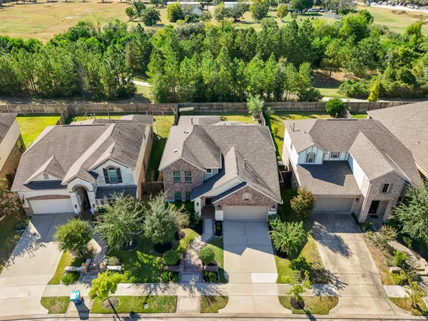 an aerial view of house with swimming pool outdoor seating and yard