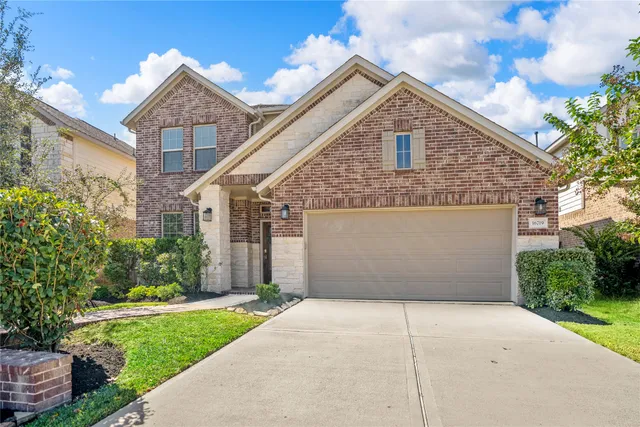 a front view of a house with a yard and garage