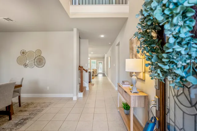 a hallway with a dining table and chairs