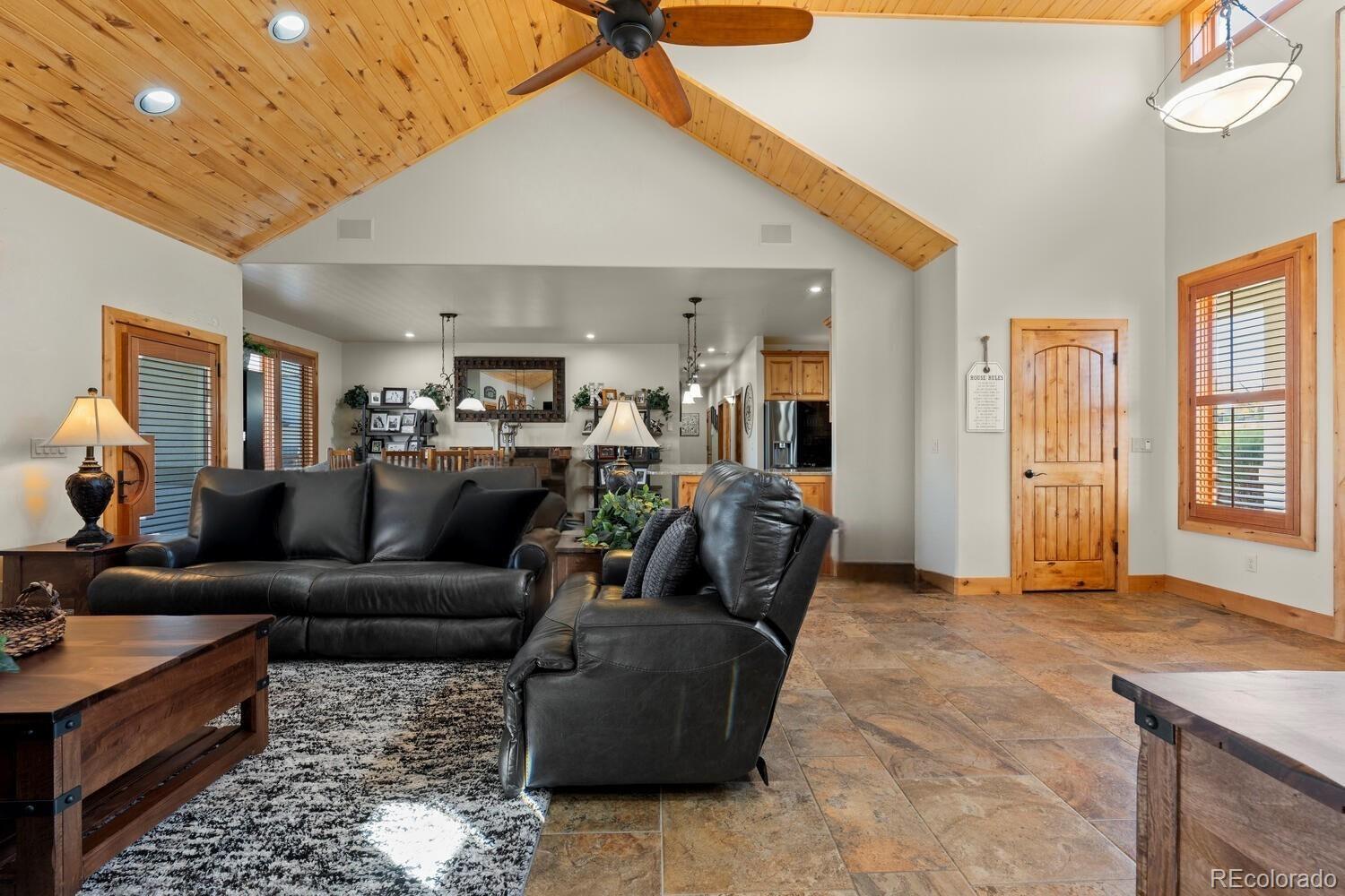 60075 Oak Grove Road Montrose, CO 81403 - Photo 12 of 50 a living room with furniture and a chandelier
