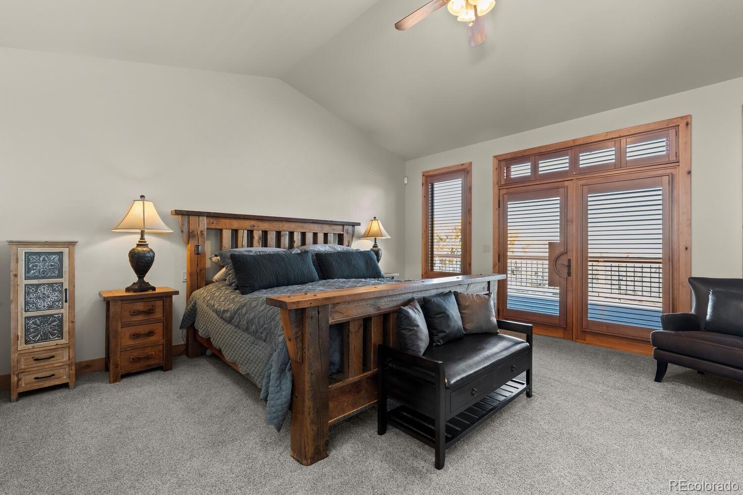 60075 Oak Grove Road Montrose, CO 81403 - Photo 15 of 50 a bedroom with a bed and a chandelier